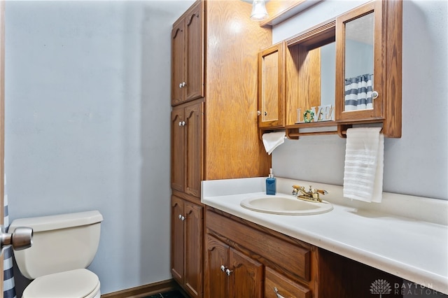 bathroom featuring vanity and toilet