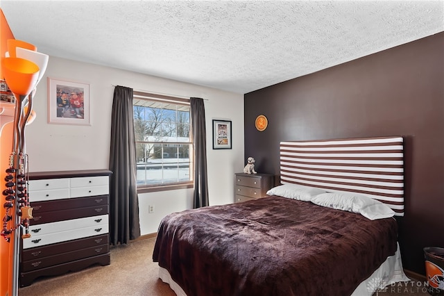 bedroom with light colored carpet and a textured ceiling