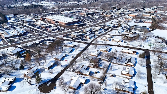 snowy aerial view with a residential view