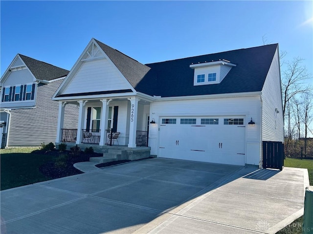 view of front facade with a porch, driveway, and an attached garage