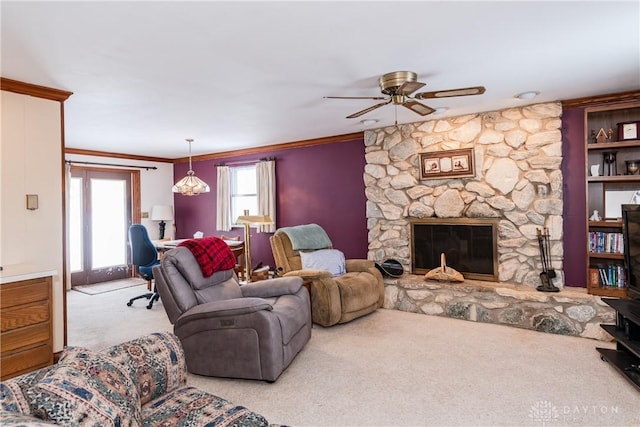 living room with a fireplace, ornamental molding, a ceiling fan, and light colored carpet