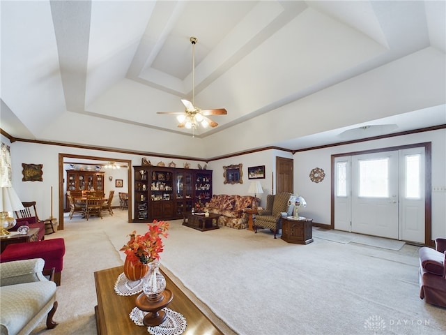 living room with light carpet, a raised ceiling, and crown molding