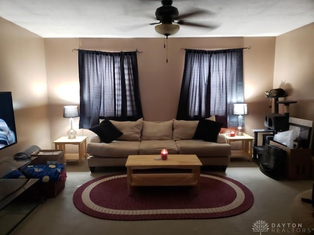 living area featuring a ceiling fan and carpet floors