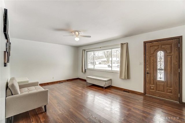 foyer featuring dark wood-style floors, visible vents, baseboards, and a ceiling fan