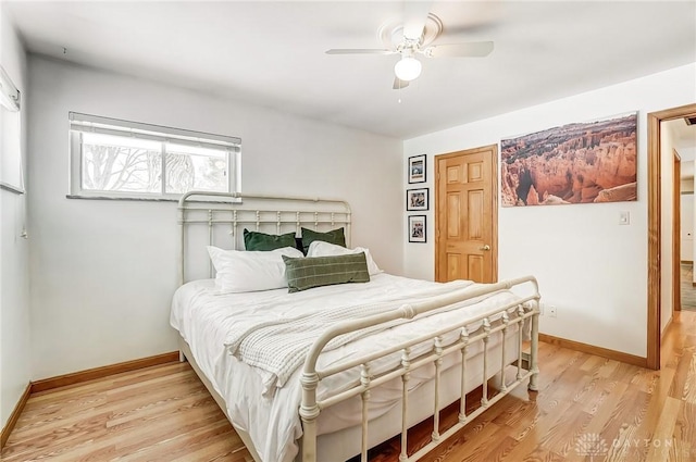 bedroom with light wood-type flooring, baseboards, and a ceiling fan