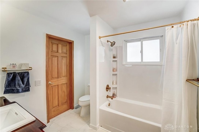 bathroom featuring toilet, shower / bath combo, and a sink