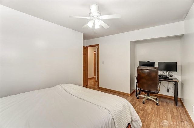 bedroom featuring light wood-type flooring, baseboards, and a ceiling fan