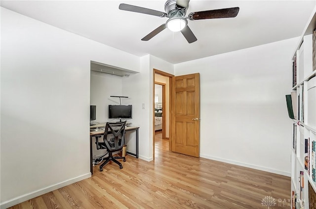 home office featuring light wood-type flooring, ceiling fan, and baseboards