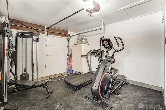 exercise area featuring a garage and attic access