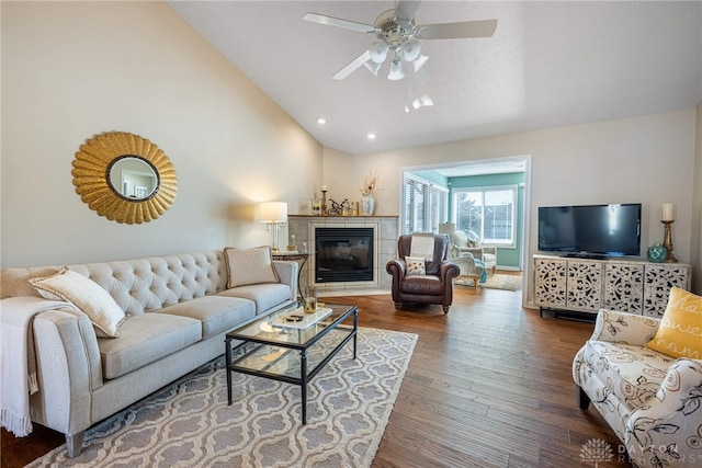 living room with ceiling fan, high vaulted ceiling, recessed lighting, a fireplace, and wood finished floors