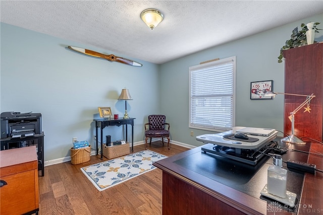 office featuring dark wood-style flooring, a textured ceiling, and baseboards