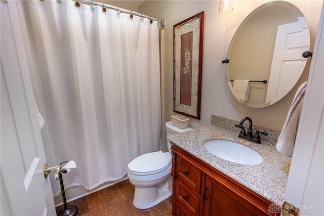 full bath with toilet, wood finished floors, and vanity