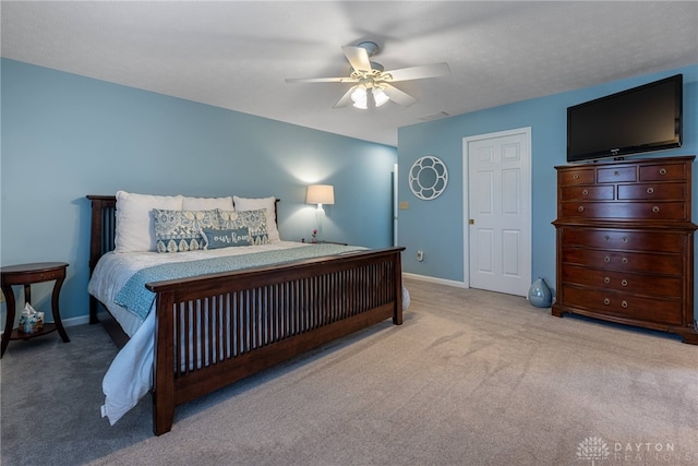 bedroom with light carpet, ceiling fan, and baseboards