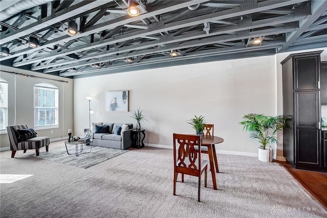 living room featuring baseboards and carpet flooring