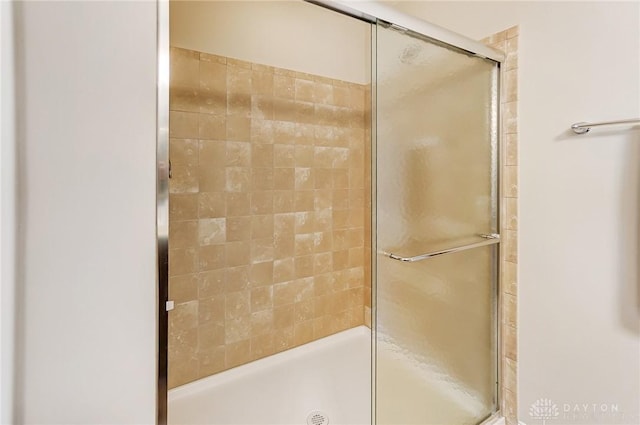 bathroom with a shower with shower door