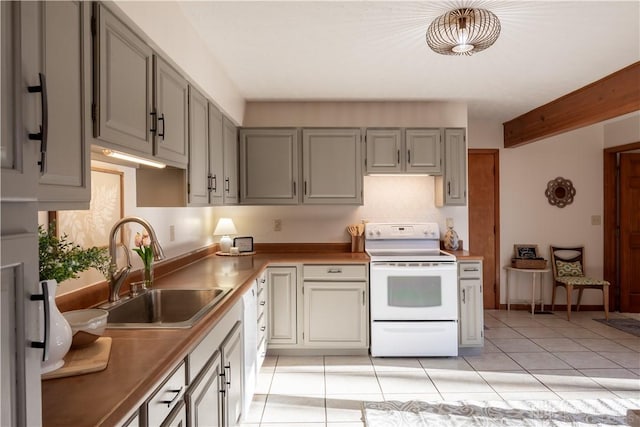 kitchen with white range with electric stovetop, a sink, baseboards, and light tile patterned floors