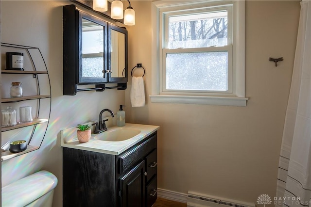 bathroom with a baseboard heating unit and vanity