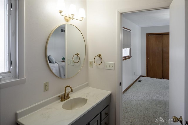 bathroom with baseboards and vanity