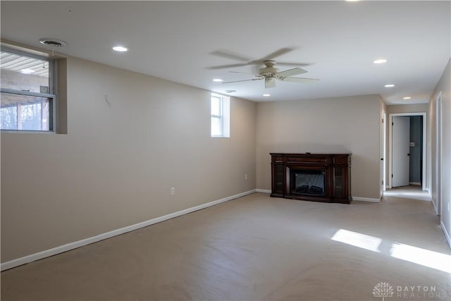 unfurnished living room with recessed lighting, concrete floors, a fireplace, visible vents, and baseboards