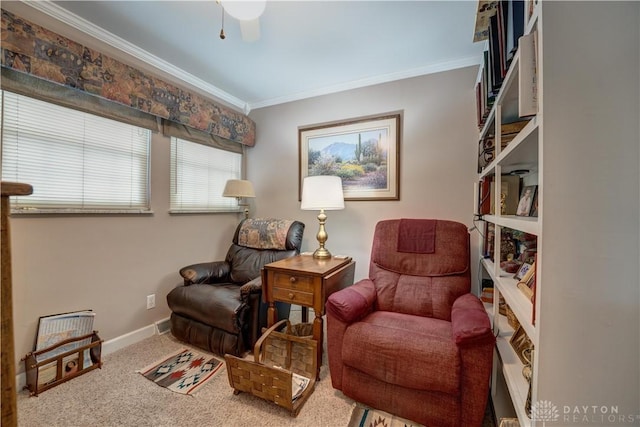 sitting room featuring carpet floors, baseboards, and ornamental molding