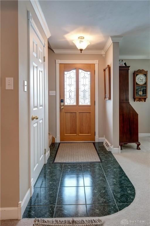 doorway with baseboards and ornamental molding