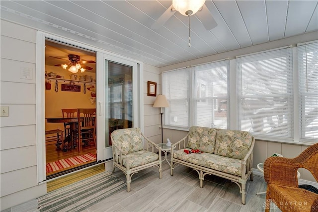 sunroom / solarium featuring ceiling fan