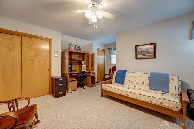 interior space featuring a ceiling fan and light colored carpet