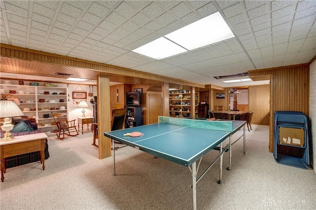 game room featuring visible vents, wood walls, and carpet