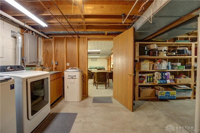 laundry area featuring laundry area, concrete block wall, and washing machine and dryer