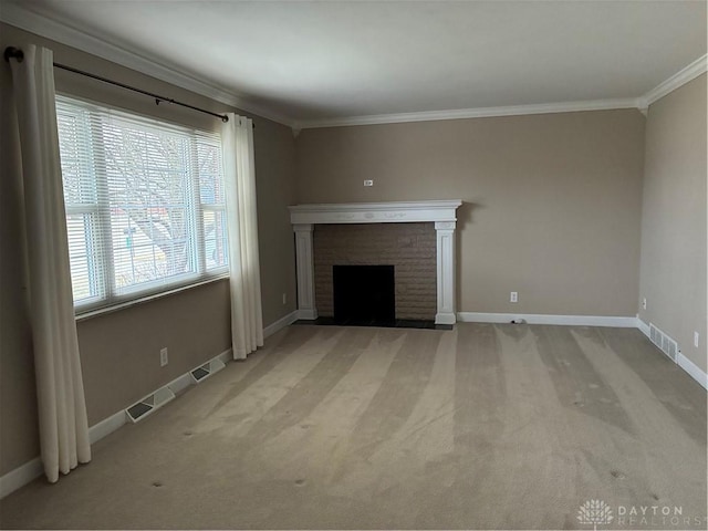 unfurnished living room with visible vents, light colored carpet, a brick fireplace, and ornamental molding