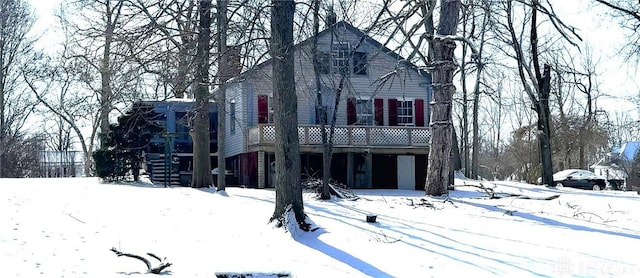 view of front facade featuring a garage and a wooden deck