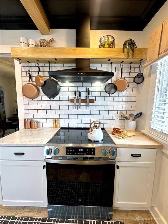 kitchen with white cabinetry, backsplash, open shelves, and stainless steel range with electric cooktop