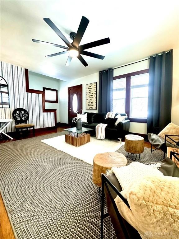 interior space featuring a ceiling fan and carpet
