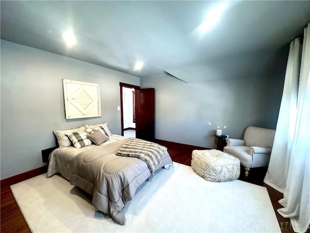 bedroom featuring baseboards and wood finished floors