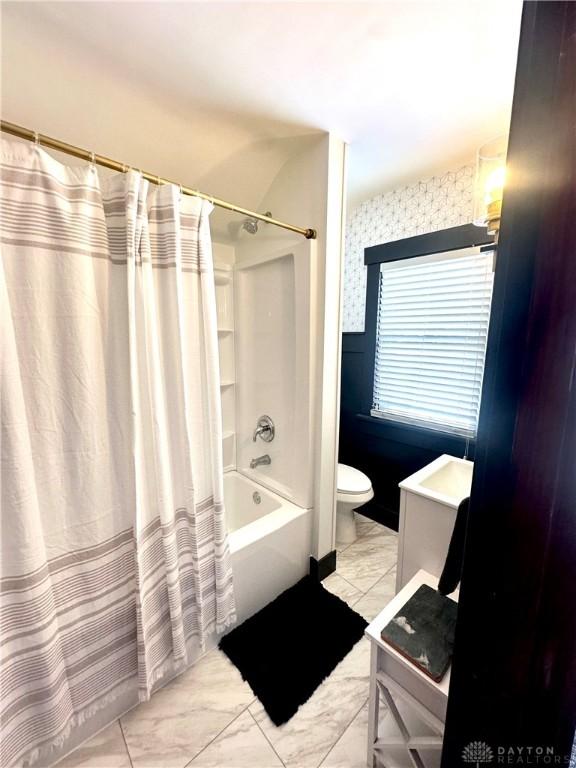 bathroom featuring shower / bath combo, marble finish floor, toilet, and vanity