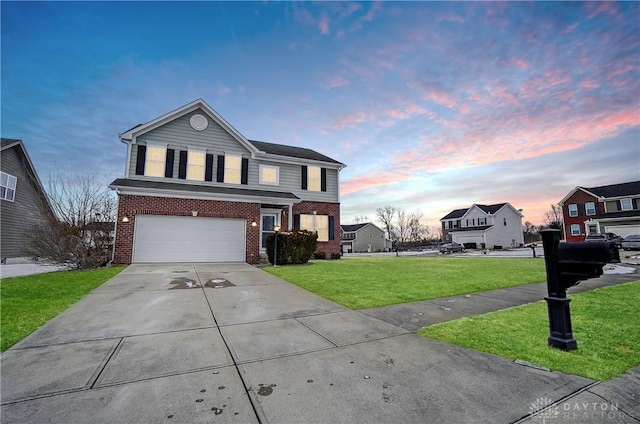 traditional-style home with concrete driveway, brick siding, a lawn, and an attached garage