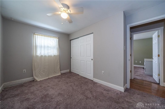 unfurnished bedroom featuring a closet, carpet, baseboards, and ceiling fan