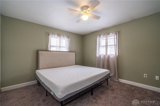 bedroom featuring carpet floors, baseboards, and multiple windows