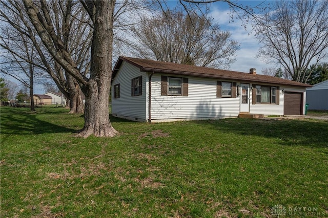 single story home featuring entry steps, a front lawn, an attached garage, and a chimney