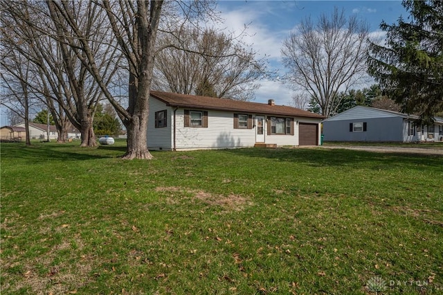 ranch-style house with a garage and a front lawn