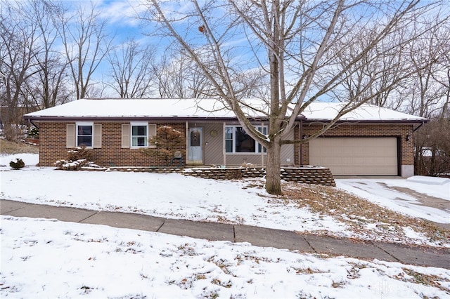 ranch-style house featuring brick siding and an attached garage