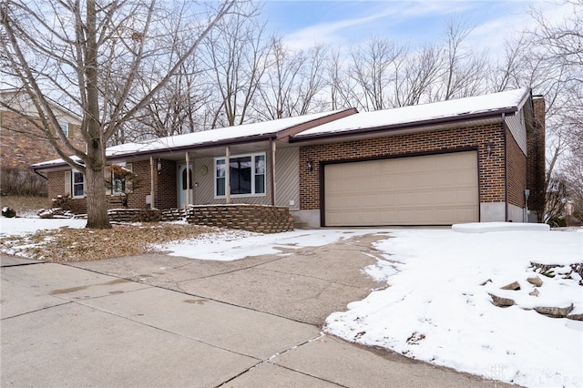 single story home featuring concrete driveway, brick siding, a chimney, and an attached garage