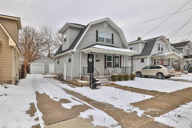 dutch colonial with a garage, covered porch, an outdoor structure, and a gambrel roof