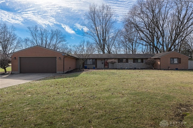 ranch-style home featuring a front yard, concrete driveway, brick siding, and an attached garage