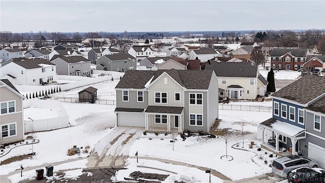 snowy aerial view featuring a residential view