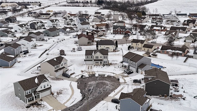 snowy aerial view with a residential view