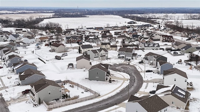 snowy aerial view featuring a residential view