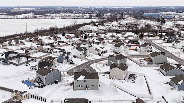 snowy aerial view with a residential view