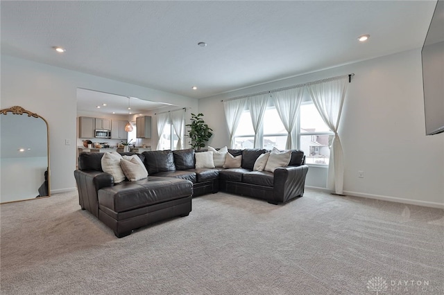 living area featuring recessed lighting, light carpet, and baseboards