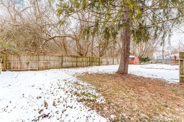 yard layered in snow featuring fence